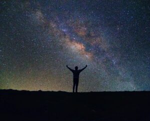 silhouette-man-standing-against-star-field-night