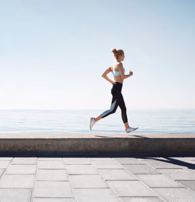 Running asian woman. Female runner training outdoors seaside ath